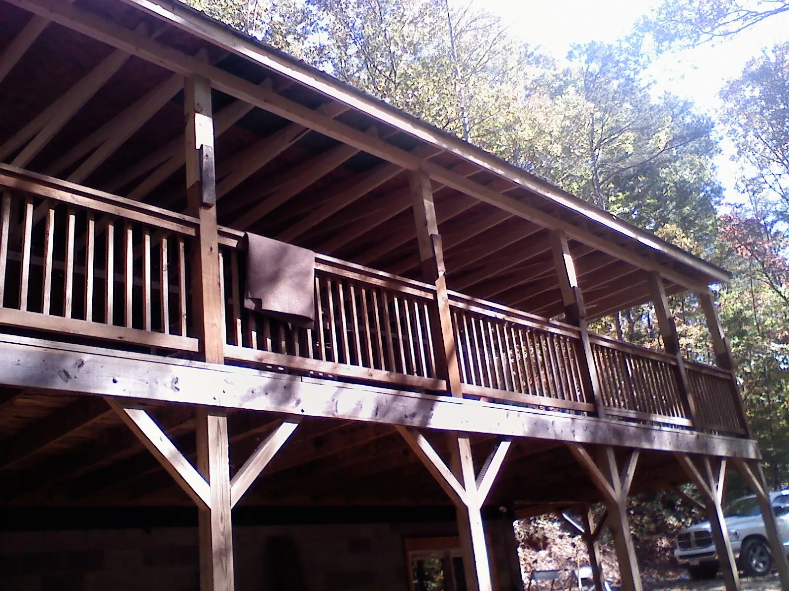 Timber framing under a new elevated porch and deck — Roof Leak Repair in Almont by Roofing Brothers